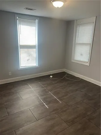 an empty room with a empty space and windows