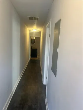 a view of a hallway with wooden floor