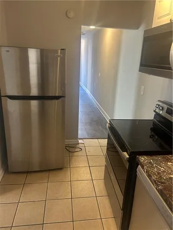 a kitchen with a refrigerator and a stove