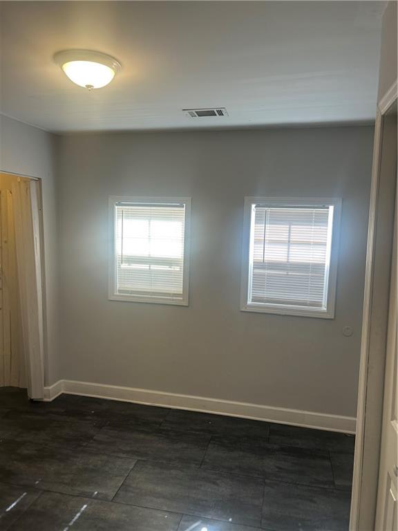 1180 Sims Street Southwest Atlanta, GA 30310 - Photo 8 of 12 a view of an empty room with wooden floor and a window