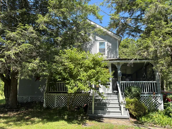 a view of a house with a small yard and wooden fence
