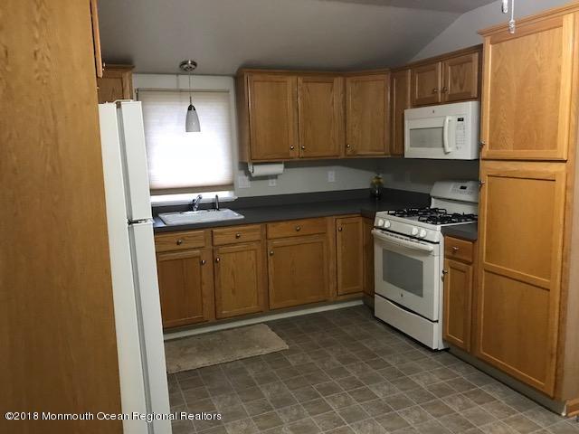 1321 Squirrel Road Wall, NJ 07719 - Photo 4 of 13 a kitchen with a sink stove and refrigerator