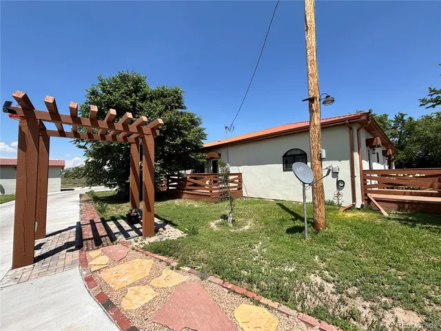 a view of a backyard with couches with wooden floor