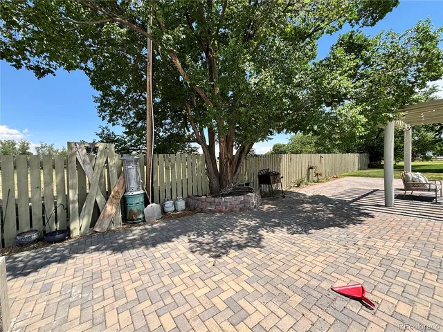 a view of a backyard with tree