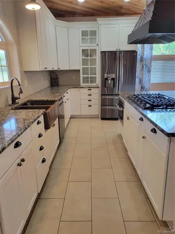 a kitchen with stainless steel appliances granite countertop a stove and a sink