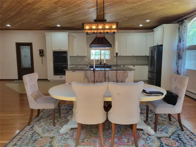 a large kitchen with a table and chairs