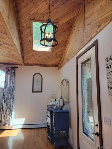 a view of a room with a dining table and chairs