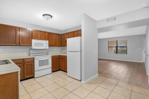 a kitchen with a sink cabinets and window