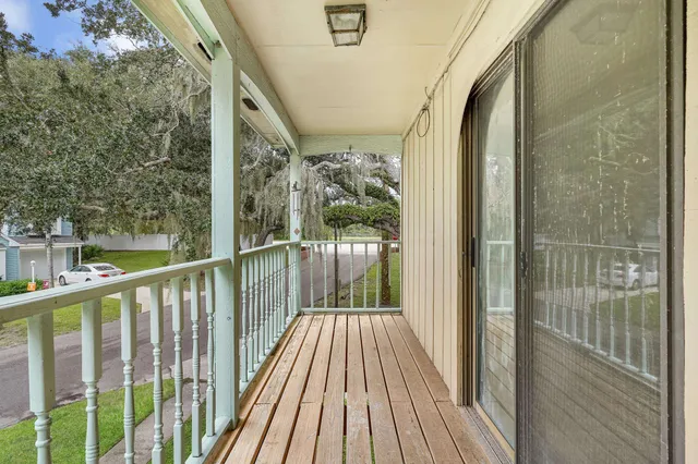 a view of a balcony with wooden floor