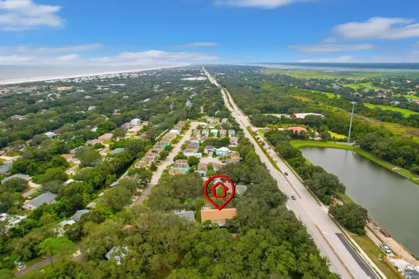 an aerial view of a house with a yard and fountain