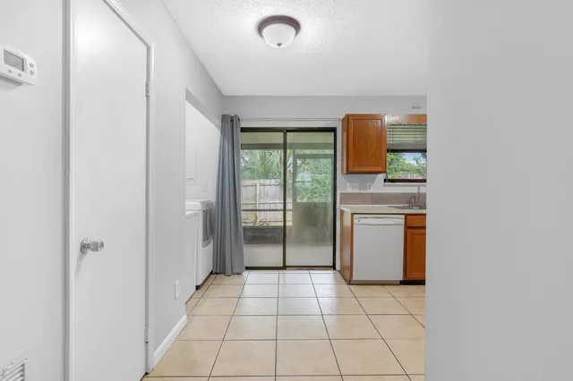 a kitchen with a refrigerator sink stove and cabinets