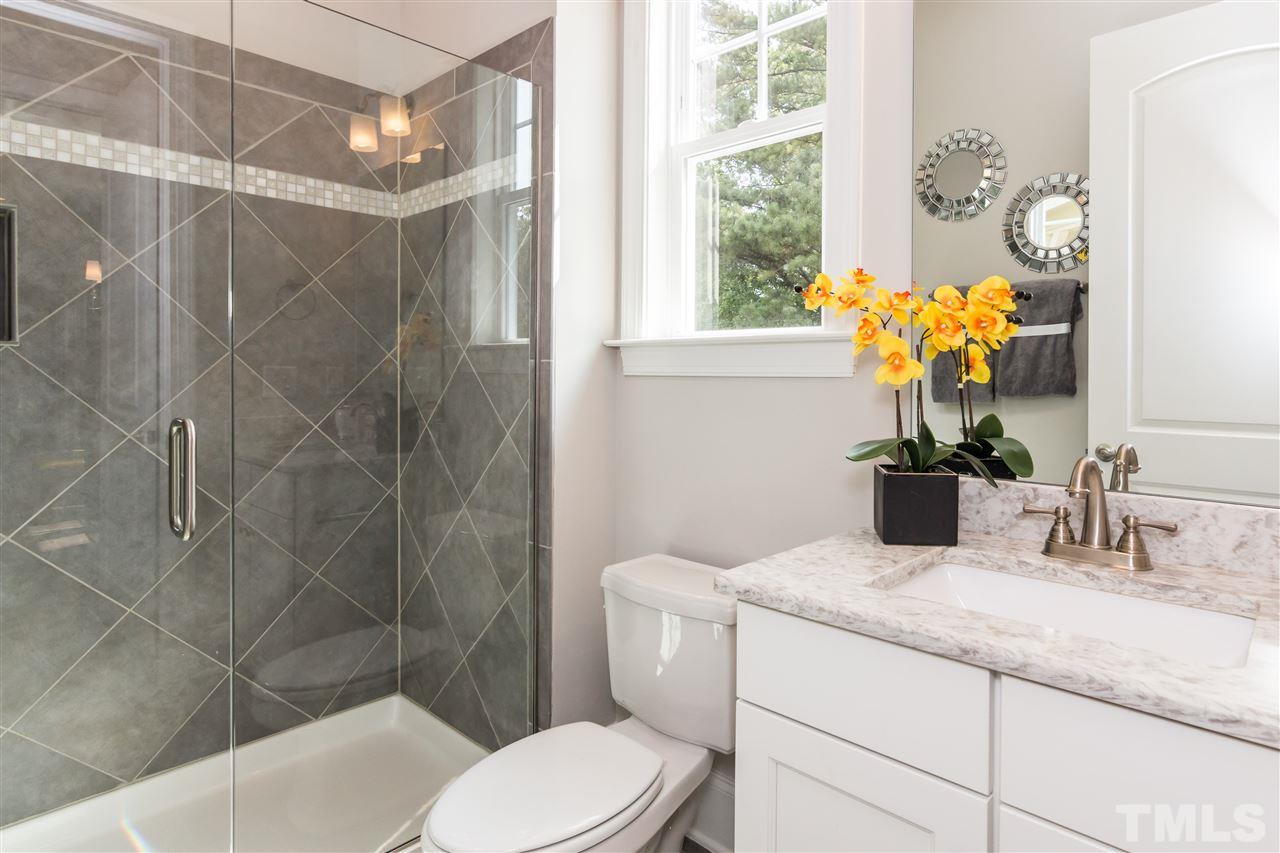 520 Belle Gate Place Cary, NC 27519 - Photo 16 of 25 a bathroom with a granite countertop sink a toilet and shower
