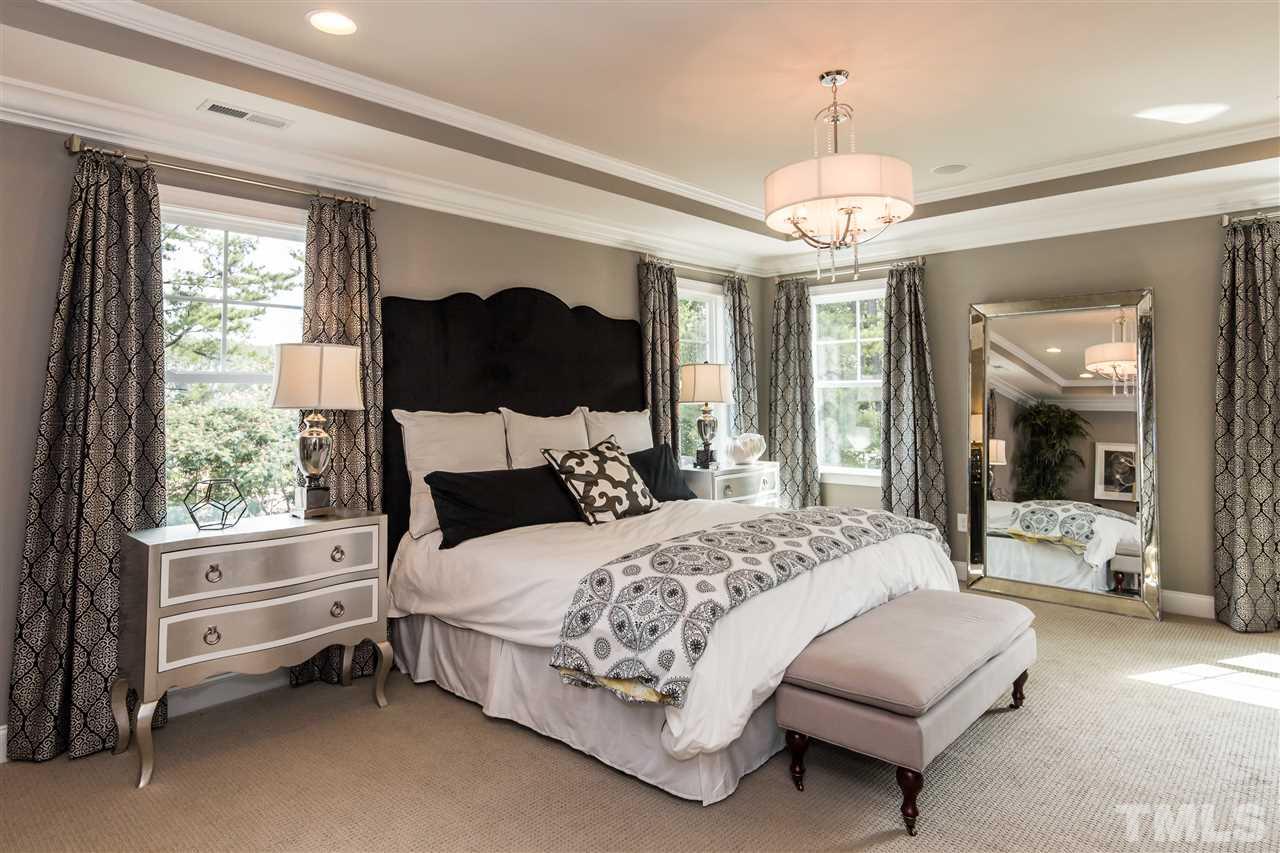 520 Belle Gate Place Cary, NC 27519 - Photo 18 of 25 a bedroom with a bed couch and window