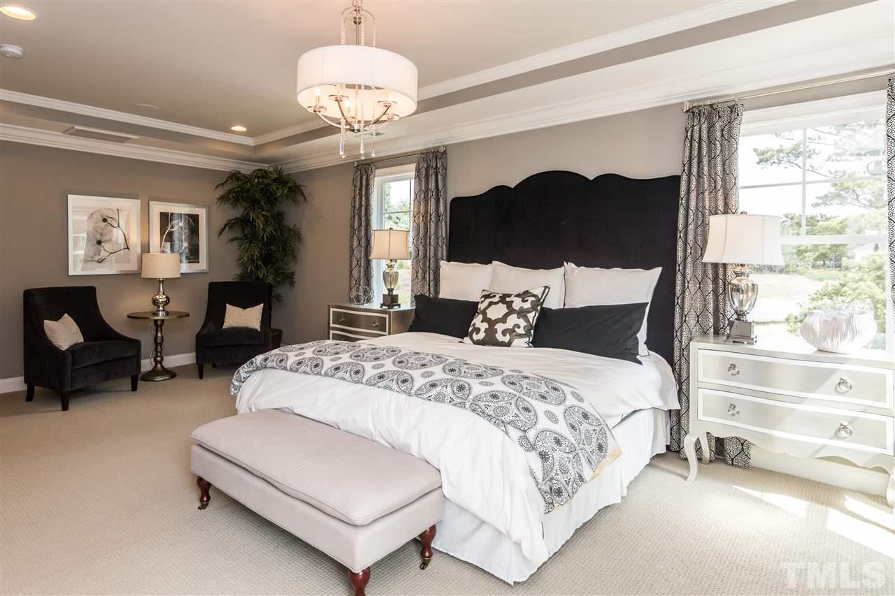 520 Belle Gate Place Cary, NC 27519 - Photo 19 of 25 a bedroom with bed mirror and window