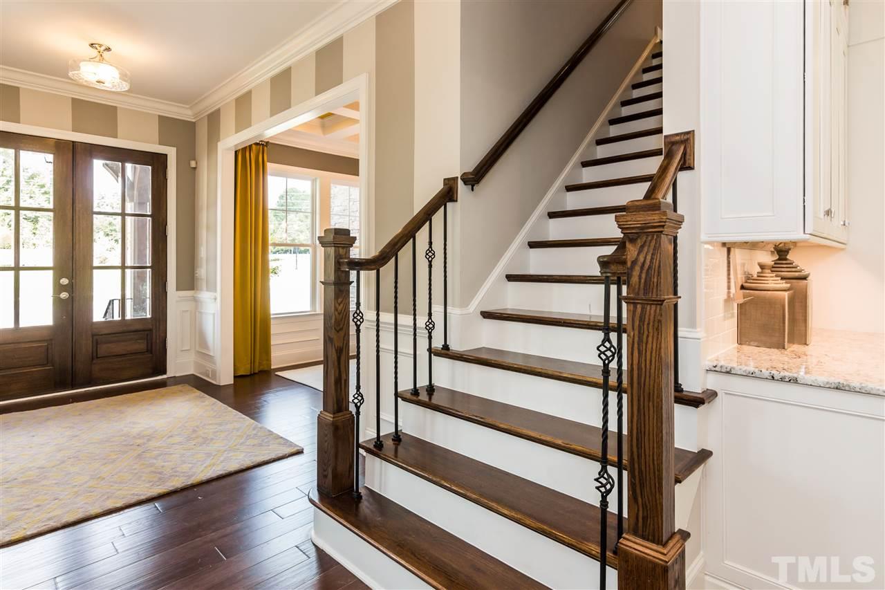 520 Belle Gate Place Cary, NC 27519 - Photo 5 of 25 a view of a hallway with wooden floor and windows