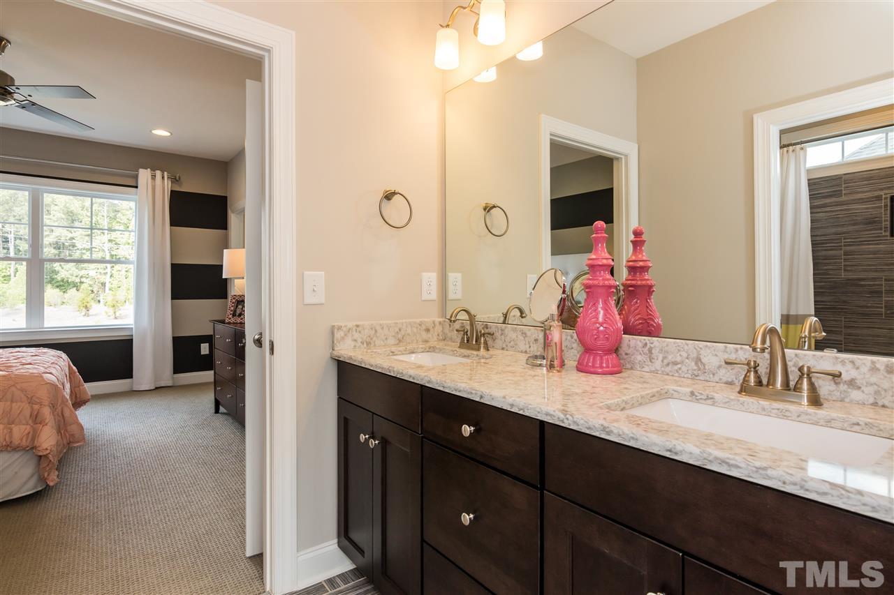 520 Belle Gate Place Cary, NC 27519 - Photo 24 of 25 a en suite bathroom with double vanity and a mirror