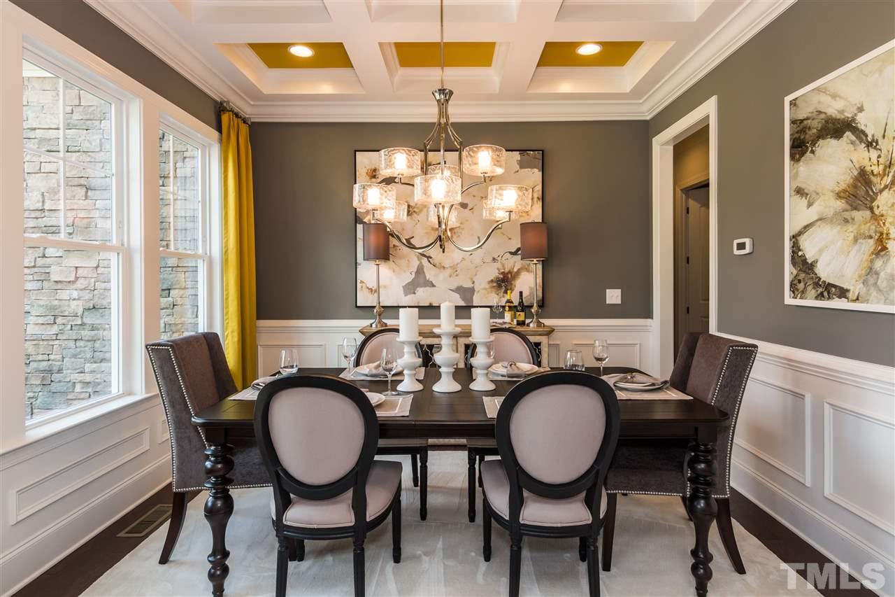 520 Belle Gate Place Cary, NC 27519 - Photo 7 of 25 a view of a dining room with furniture wooden floor and chandelier