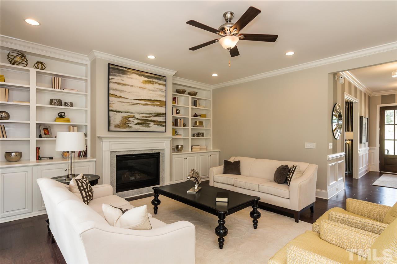520 Belle Gate Place Cary, NC 27519 - Photo 9 of 25 a living room with furniture and a fireplace