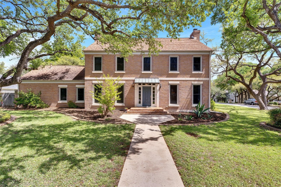 911 Ridgewood Road Austin, TX 78746 - Photo 1 of 1 a front view of a house with yard and green space
