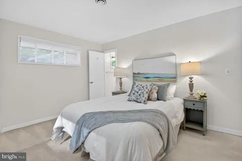 a bedroom with a bed and a night stand