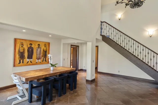 a spacious bedroom with furniture and a fireplace