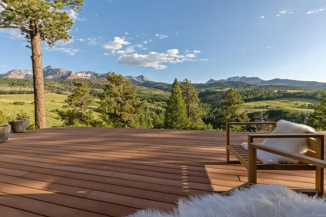 a bedroom with a large bed and a fireplace