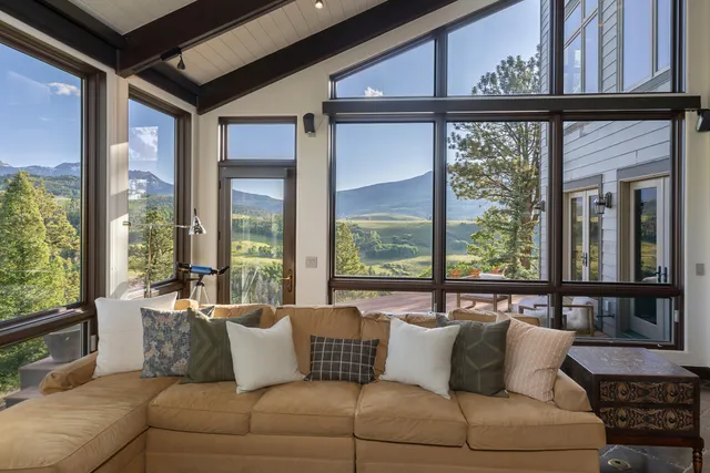 a living room with furniture and large windows