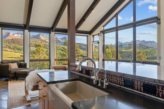 a view of a dining room with furniture large window and wooden floor