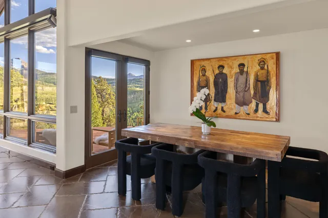 a bed room with a bed and large windows