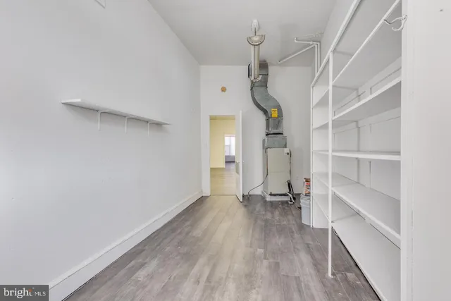 a view of empty room with wooden floor and window