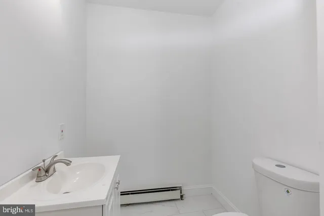 a white toilet sitting next to a white sink
