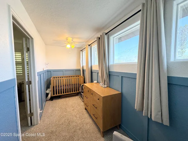 a bathroom with a granite countertop sink a mirror and a toilet