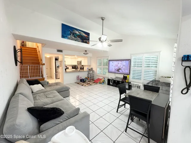 a room with gym equipment and large windows