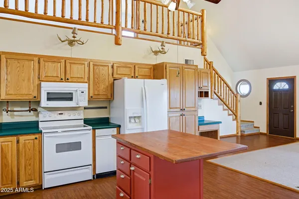 a kitchen with refrigerator cabinets and wooden floor
