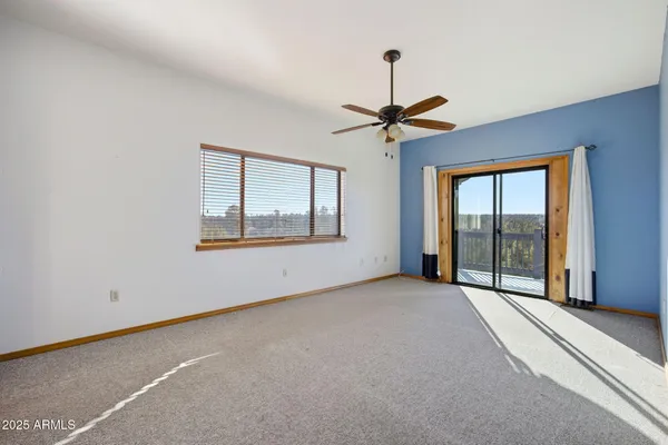a view of a livingroom with a chandelier fan and closet
