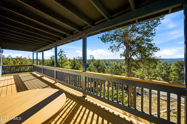 a view of a porch with a table and chairs