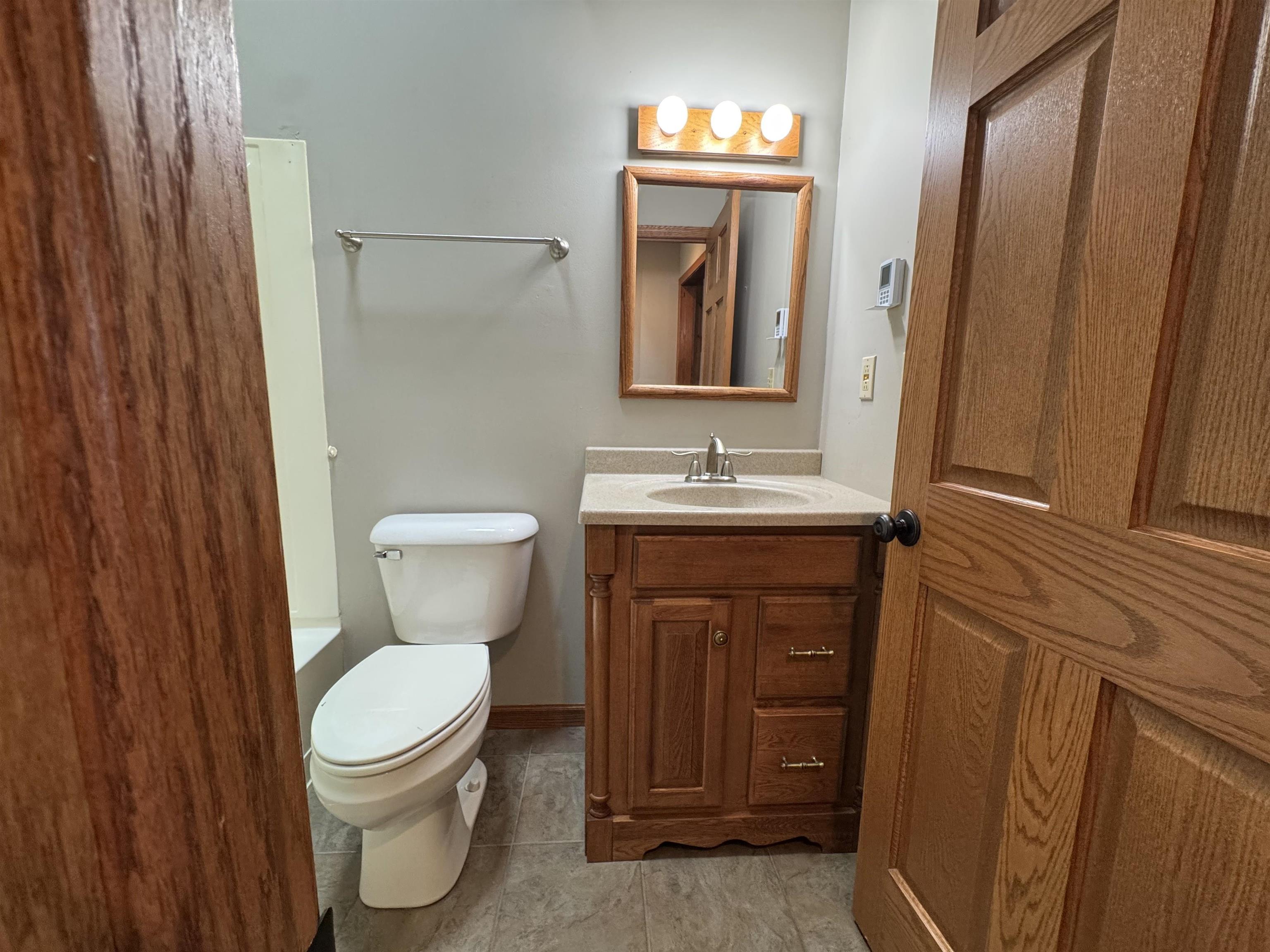 25303 Spring Valley Road Shannon, IL 61078 - Photo 17 of 22 a bathroom with a toilet sink and mirror