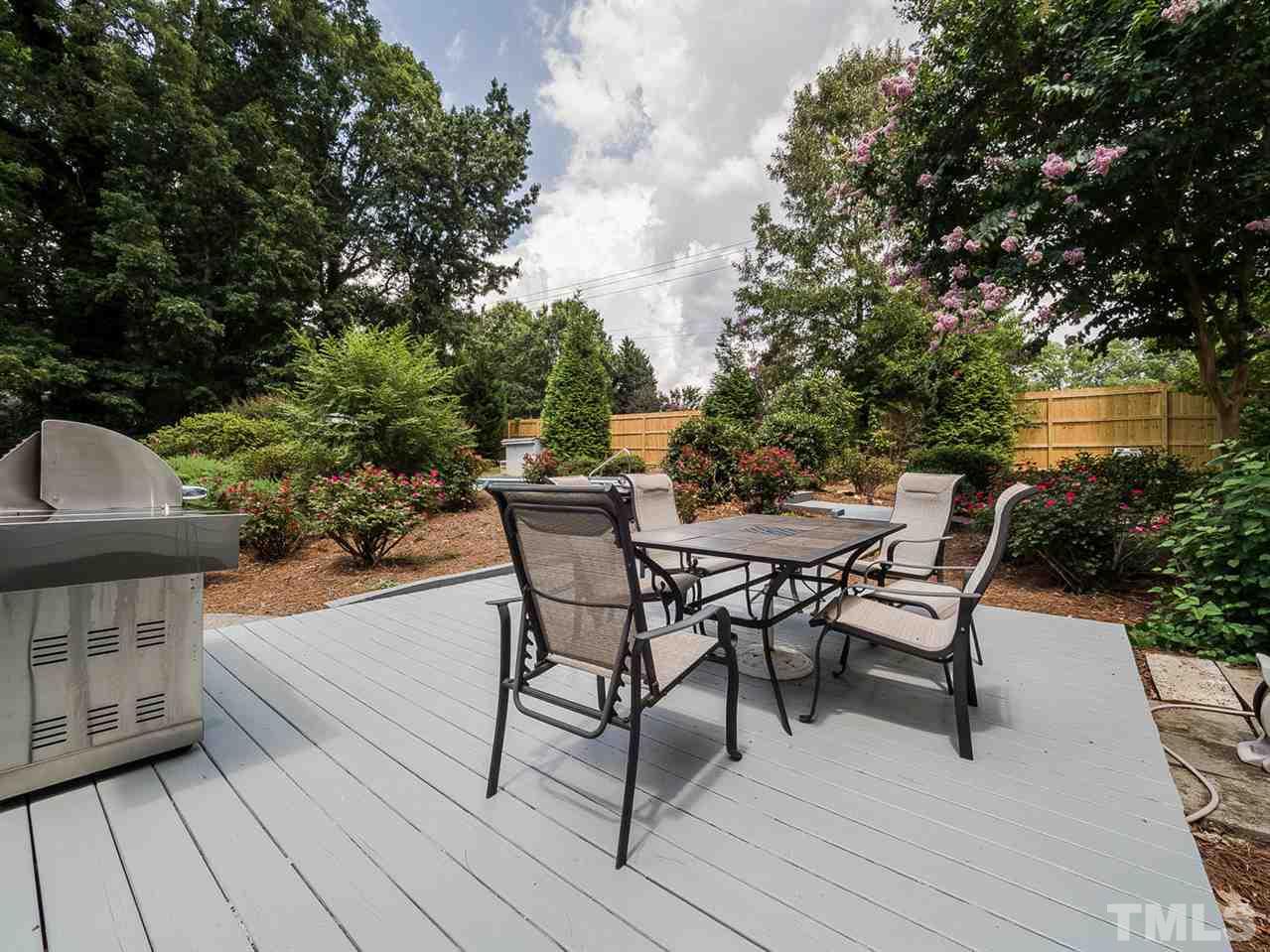 8913 Brookstone Court Raleigh, NC 27615 - Photo 22 of 25 a view of a roof deck with table and chairs and potted plants