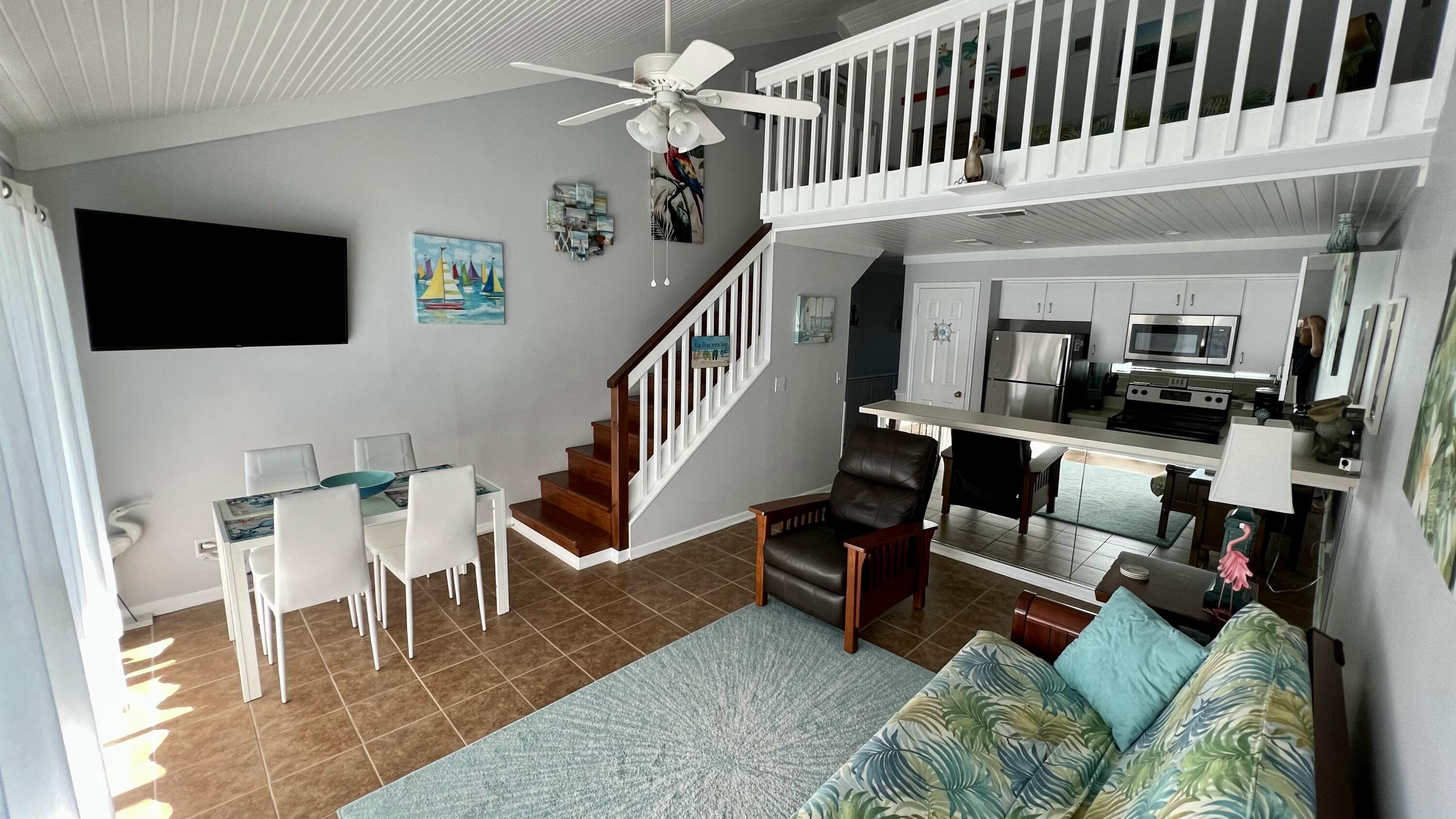4984 West County Highway 30A, Unit 5B Santa Rosa Beach, FL 32459 - Photo 6 of 46 a living room with furniture and a flat screen tv
