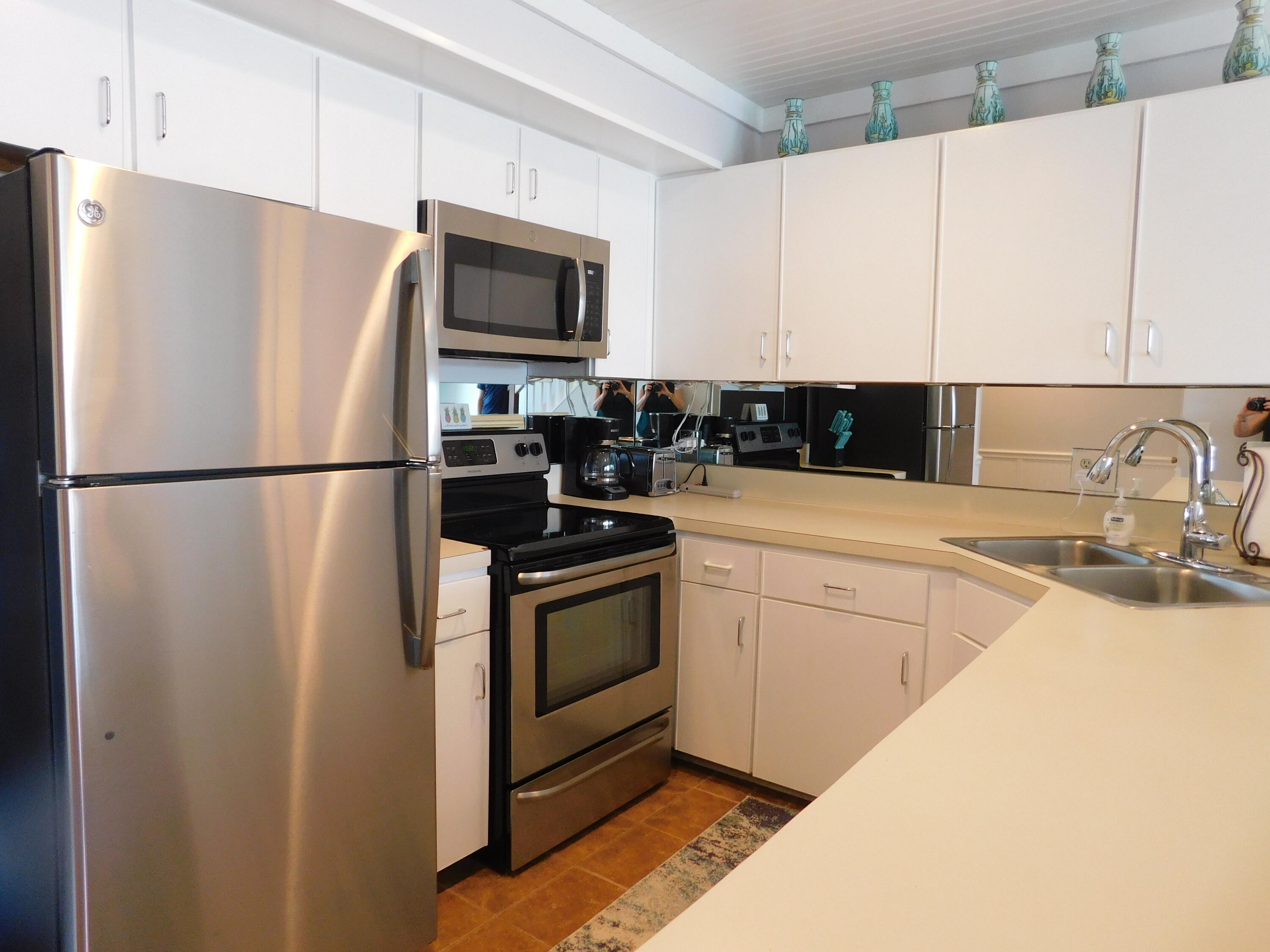 4984 West County Highway 30A, Unit 5B Santa Rosa Beach, FL 32459 - Photo 10 of 46 a kitchen with a refrigerator sink and microwave