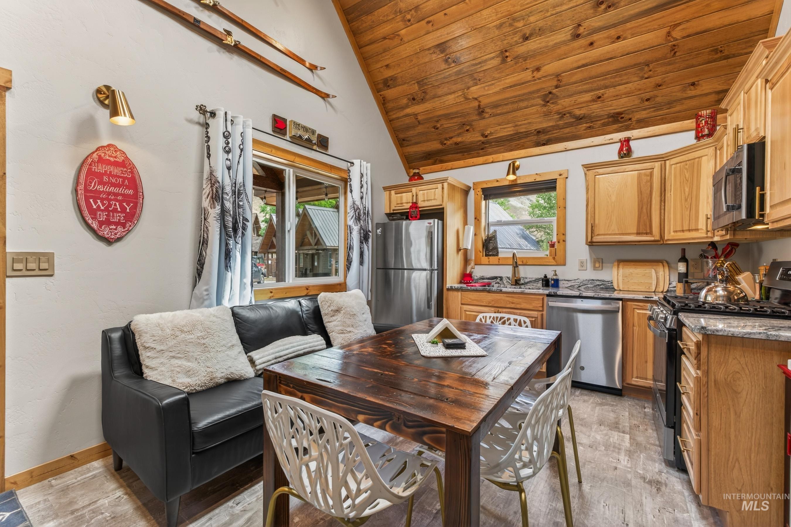1432 Salmon Drive Riggins, ID 83549 - Photo 10 of 39 Vaulted wood-paneled ceiling above a kitchen featuring wood cabinetry, stainless steel appliances, and stone-finish countertops