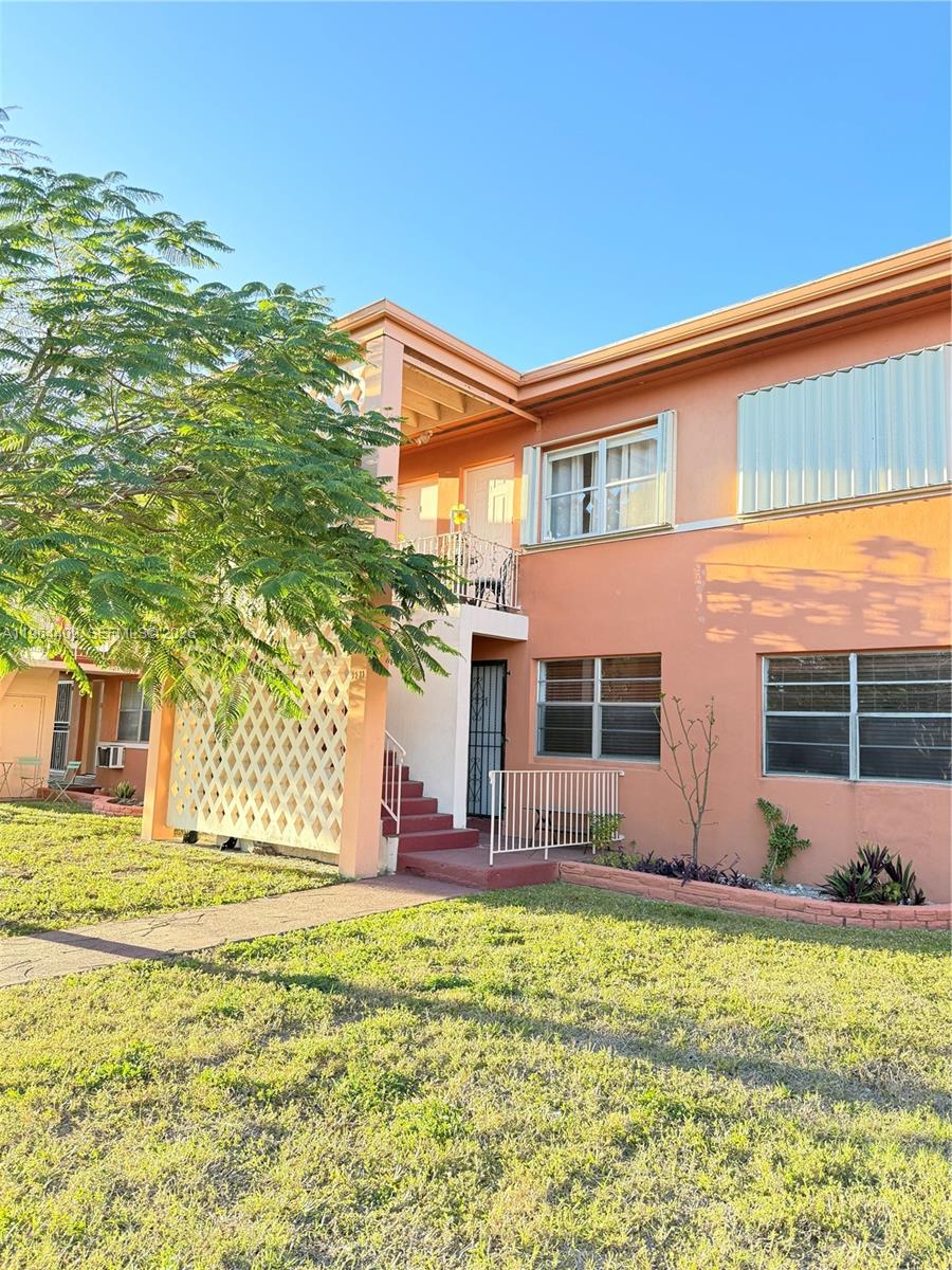 3411 Southwest 11th Street, Unit 3B Miami, FL 33135 - Photo 1 of 14 a front view of a house with a yard