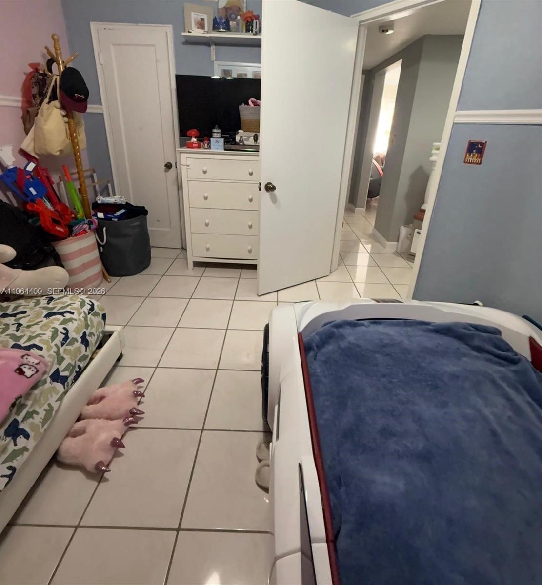 3411 Southwest 11th Street, Unit 3B Miami, FL 33135 - Photo 12 of 14 a bedroom with a bed and flat screen tv