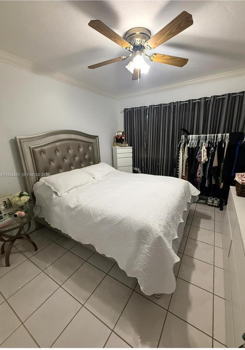 3411 Southwest 11th Street, Unit 3B Miami, FL 33135 - Photo 14 of 14 a bedroom with a bed and a chandelier