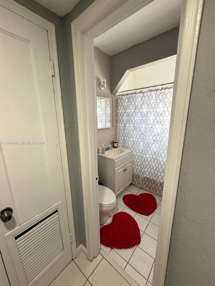 3411 Southwest 11th Street, Unit 3B Miami, FL 33135 - Photo 7 of 14 a bathroom with a sink toilet and shower