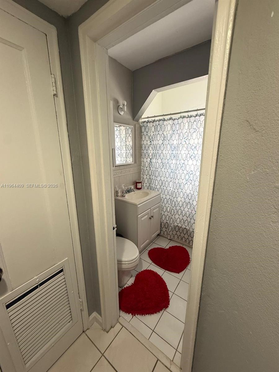 3411 Southwest 11th Street, Unit 3B Miami, FL 33135 - Photo 9 of 14 a bathroom with a sink toilet and shower