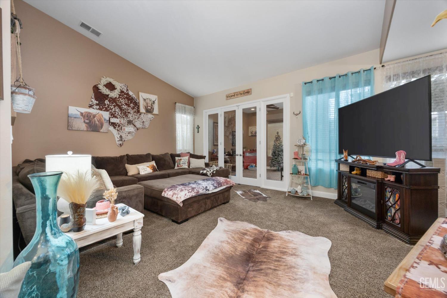 Undisclosed Address Bakersfield, CA 93312 - Photo 11 of 47 a living room with furniture and a flat screen tv
