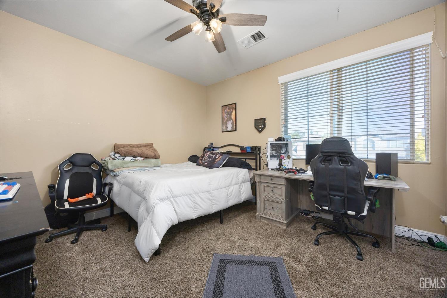 Undisclosed Address Bakersfield, CA 93312 - Photo 13 of 47 a bedroom with a bed and a chandelier