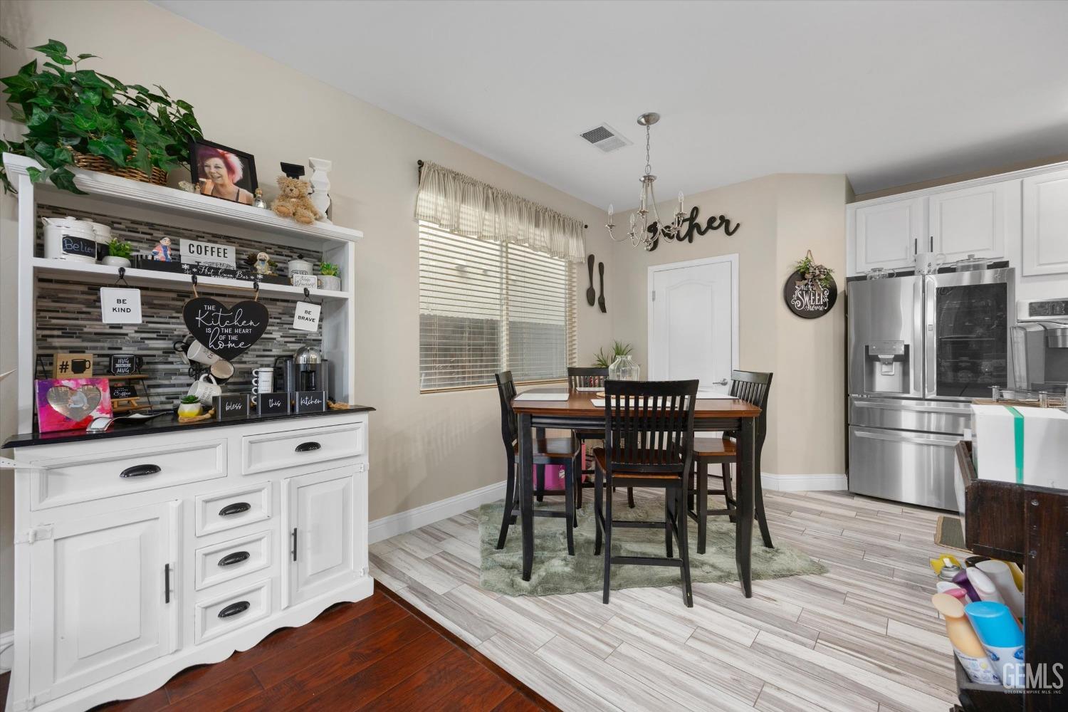 Undisclosed Address Bakersfield, CA 93312 - Photo 18 of 47 a view of a dining room with furniture and wooden floor