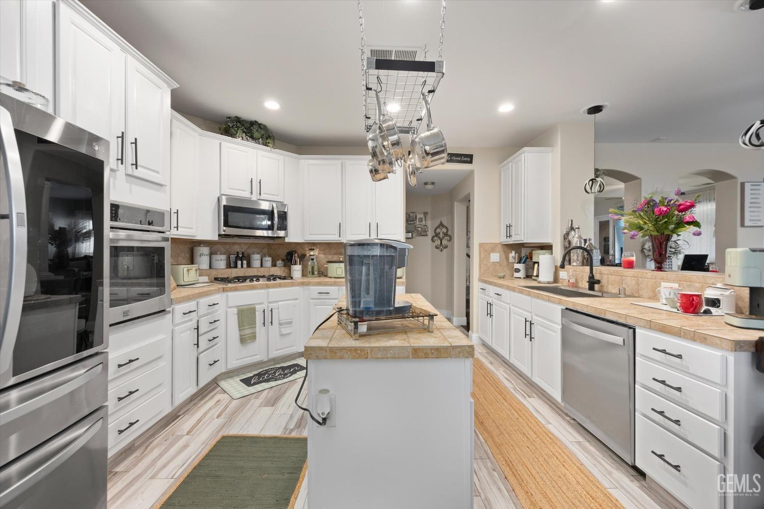 Undisclosed Address Bakersfield, CA 93312 - Photo 19 of 47 a kitchen with kitchen island granite countertop a sink cabinets stainless steel appliances and a counter top space